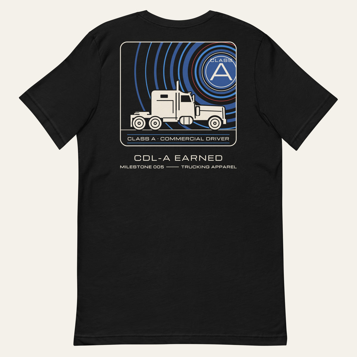 Flat lay of the black CDL-A Earned Milestone Tee, back view with the printed mission-patch style graphic