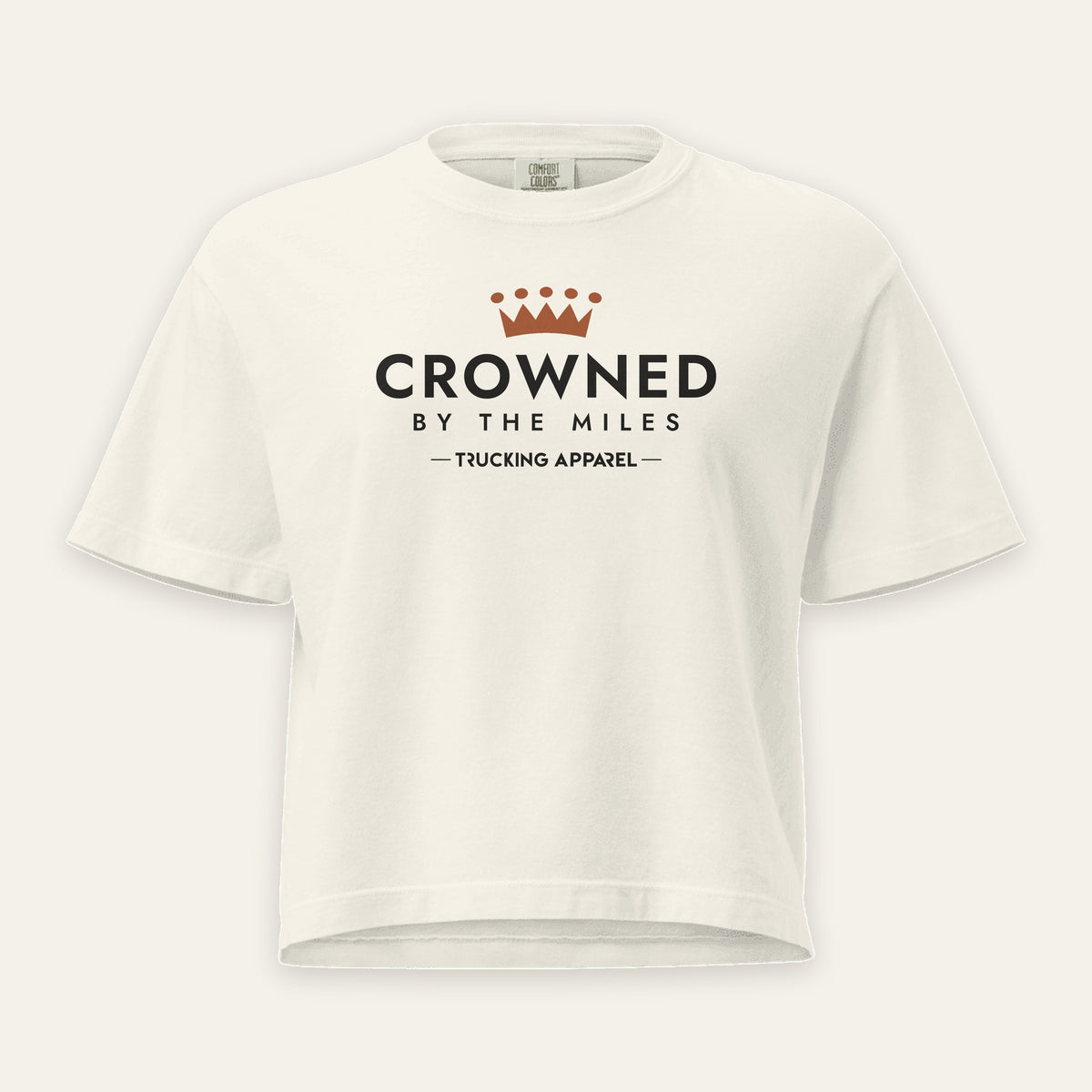 Crowned by the Miles Boxy Tee in Ivory, front view, crown over CROWNED BY THE MILES lettering, on a cream background