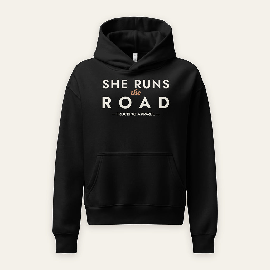 She Runs the Road Hoodie in Black, front view, SHE RUNS THE ROAD chest lettering, on a cream background