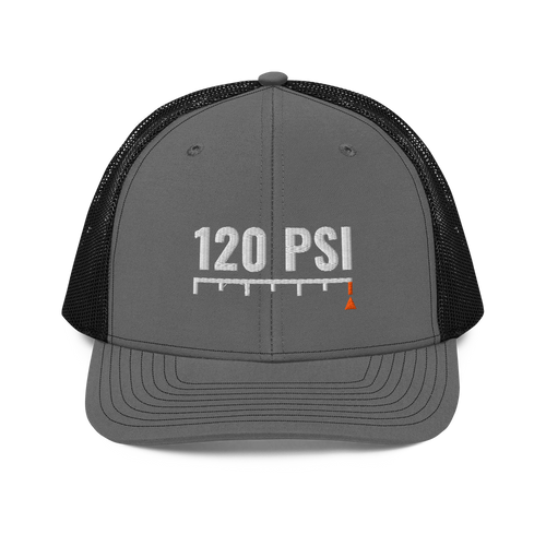 120 PSI Trucker Hat, charcoal and black Richardson 112 mesh-back cap with 120 PSI in white embroidery over a gauge scale with an orange needle, front view