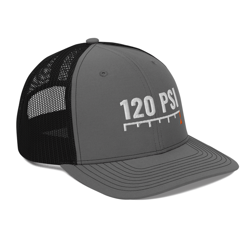 120 PSI Trucker Hat, charcoal and black Richardson 112 mesh-back cap with 120 PSI in white embroidery over a gauge scale with an orange needle, right front angle