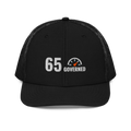 65 Governed Trucker Hat, black Richardson 112 mesh-back cap with 65 GOVERNED in white and grey embroidery with an orange speedometer needle, front view