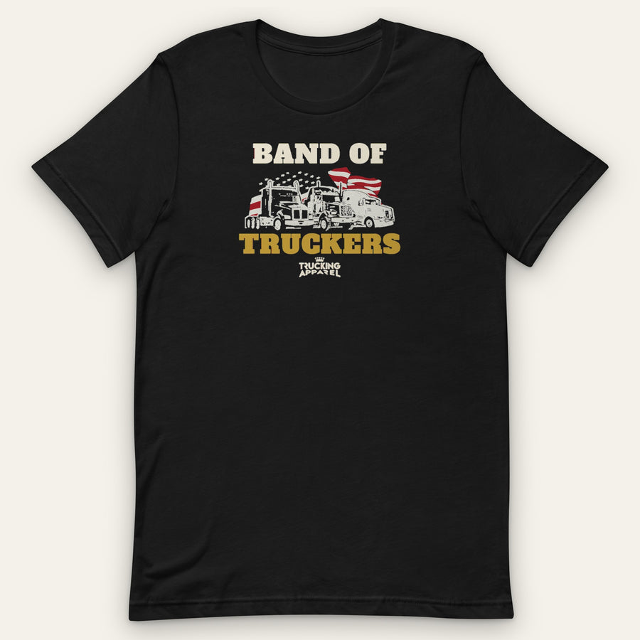 Band of Truckers Tee, front view laid flat showing BAND OF TRUCKERS around three big rigs in front of a waving American flag and a field of stars, with the Trucking Apparel crown logo underneath.