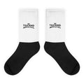 Trucking Socks in black and white with Trucking Apparel crown logo, flat view.
