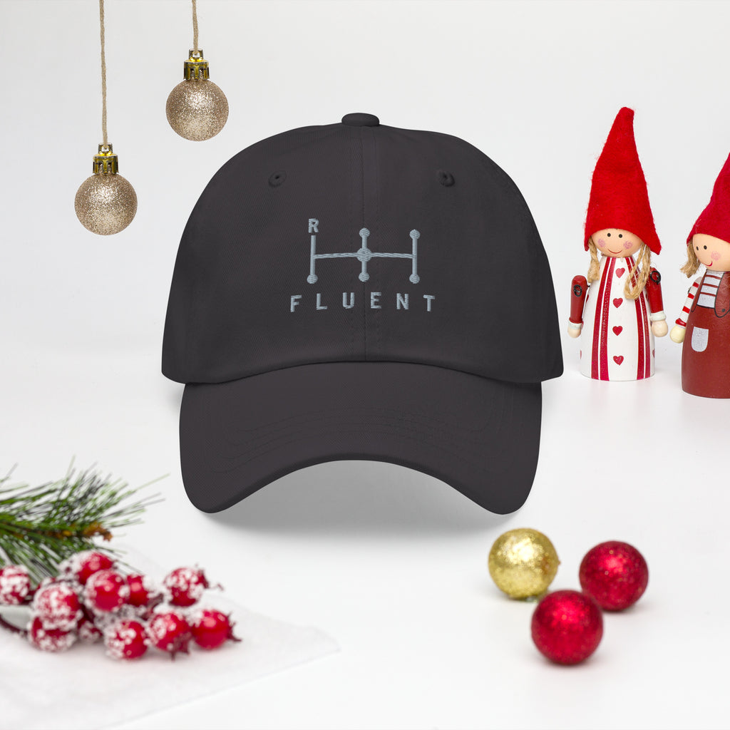 Fluent Dad Cap in dark grey, front view in a Christmas scene with ornaments.