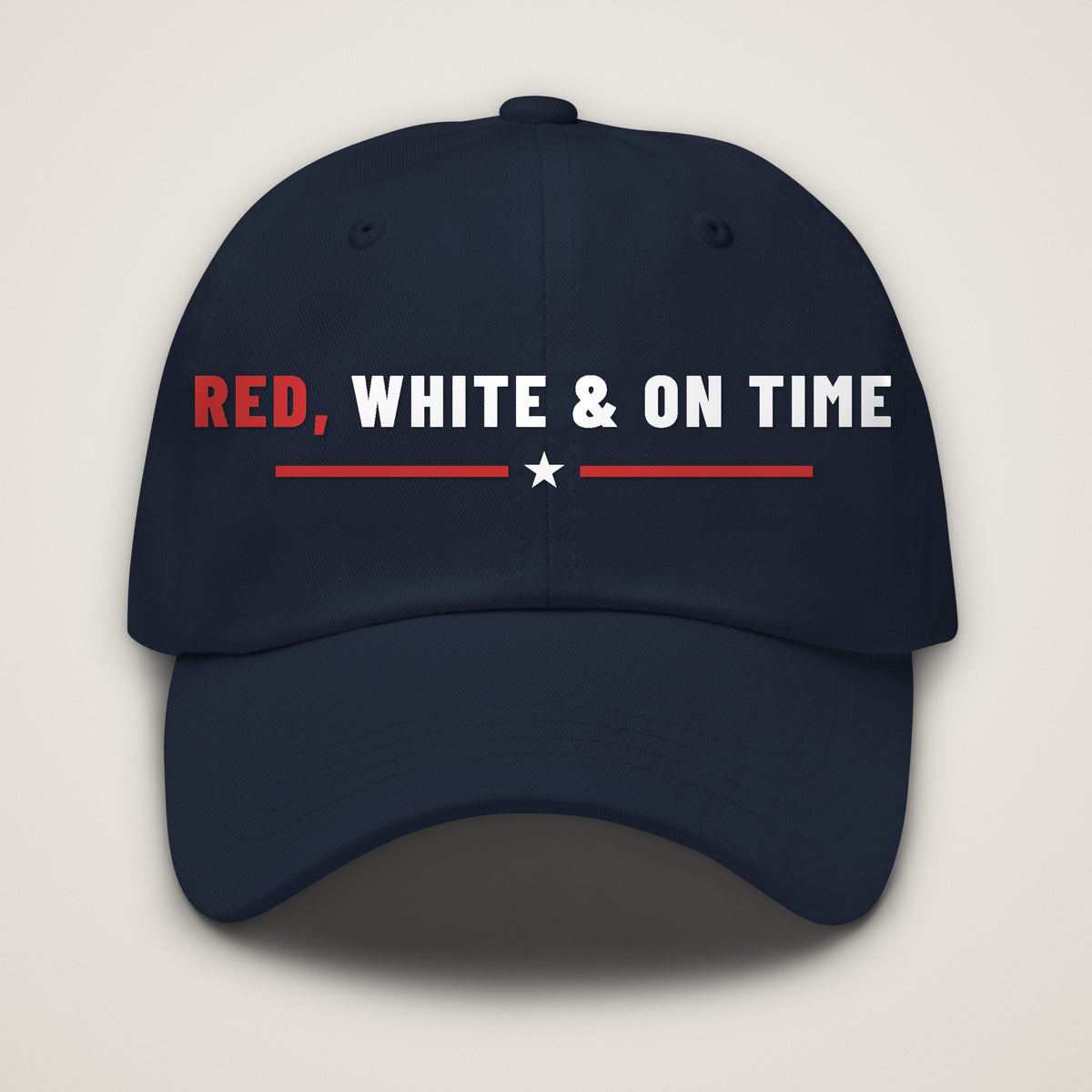 Red, White & On Time Dad Hat, navy Yupoong 6245CM dad hat with RED, WHITE & ON TIME embroidered in red and white over a red rule with a white star, front view.