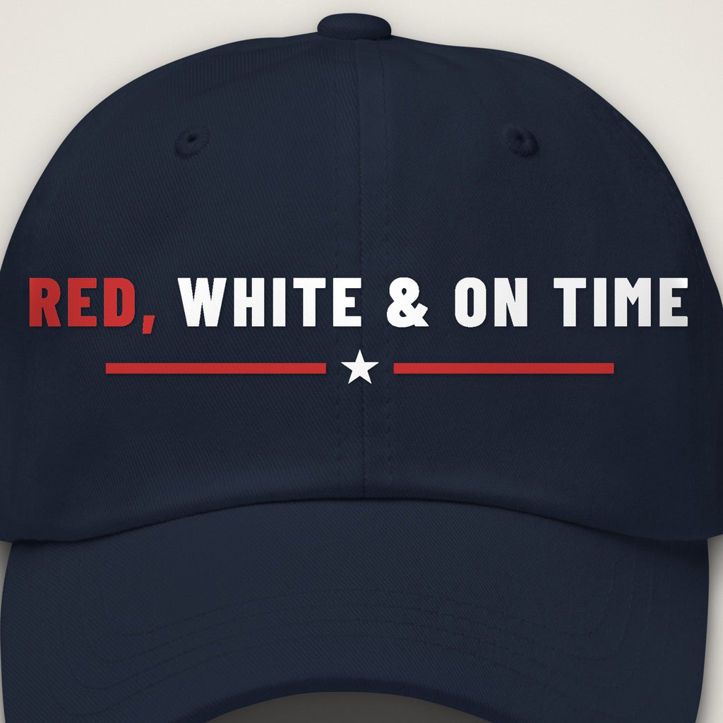 Red, White & On Time Dad Hat, close-up of the front embroidery on the navy dad hat: RED, WHITE & ON TIME embroidered in red and white over a red rule with a white star.