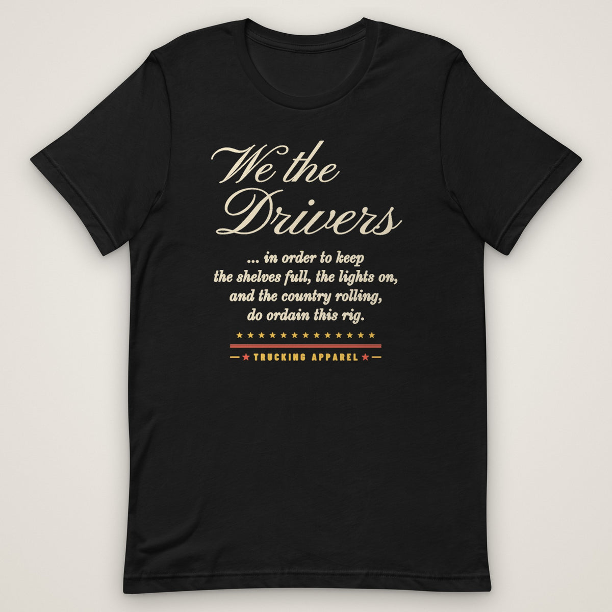 We the Drivers Tee in black, front view laid flat showing the full-front We the Drivers script with the preamble-style lines underneath and the Trucking Apparel signature.