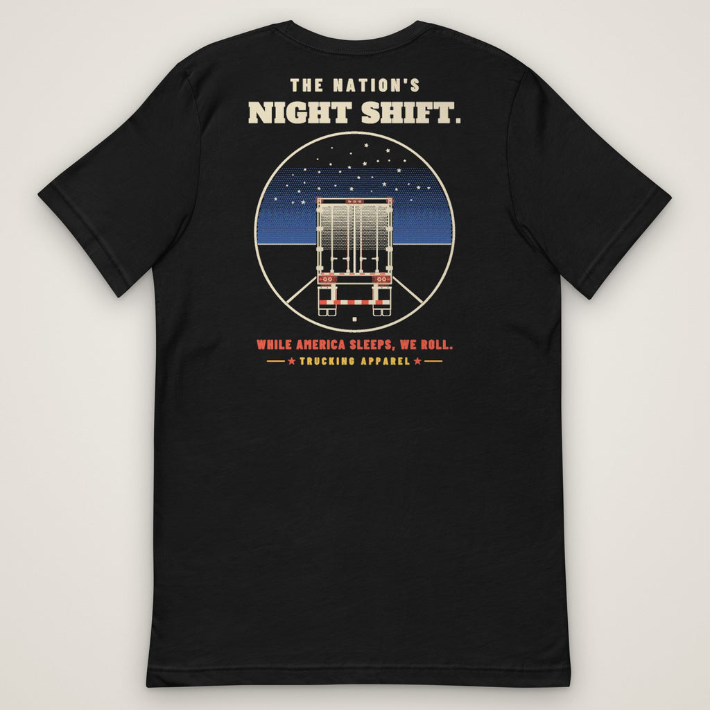 The Nation's Night Shift Tee in black, back view laid flat showing the back print reading THE NATION'S NIGHT SHIFT: a trailer's rear view on a night highway under stars, with WHILE AMERICA SLEEPS, WE ROLL.
