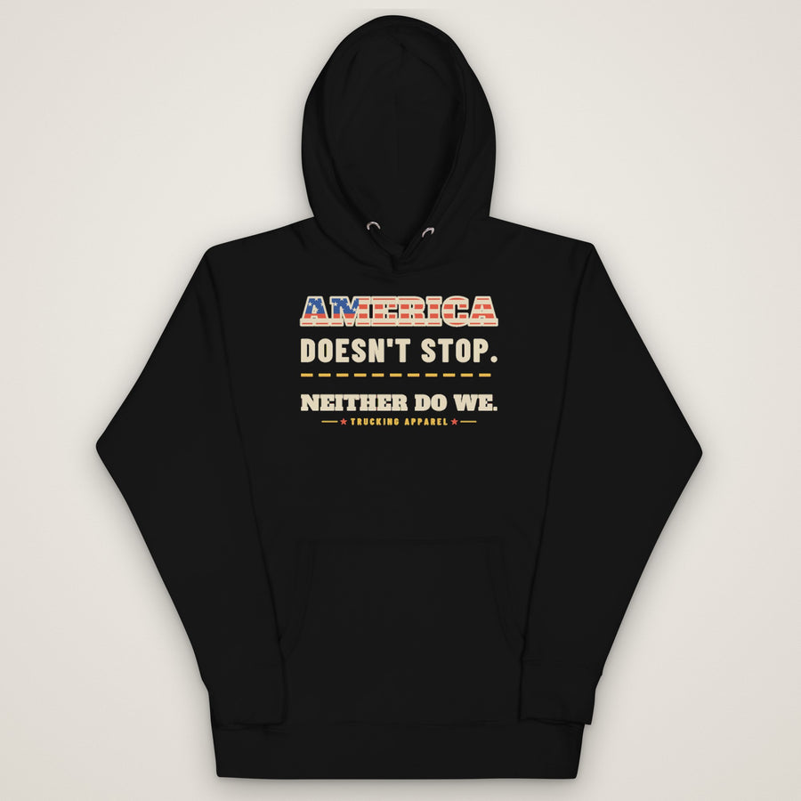 America Doesn't Stop Hoodie in black, front view laid flat showing the AMERICA DOESN'T STOP. NEITHER DO WE. front print with stars-and-stripes lettering.