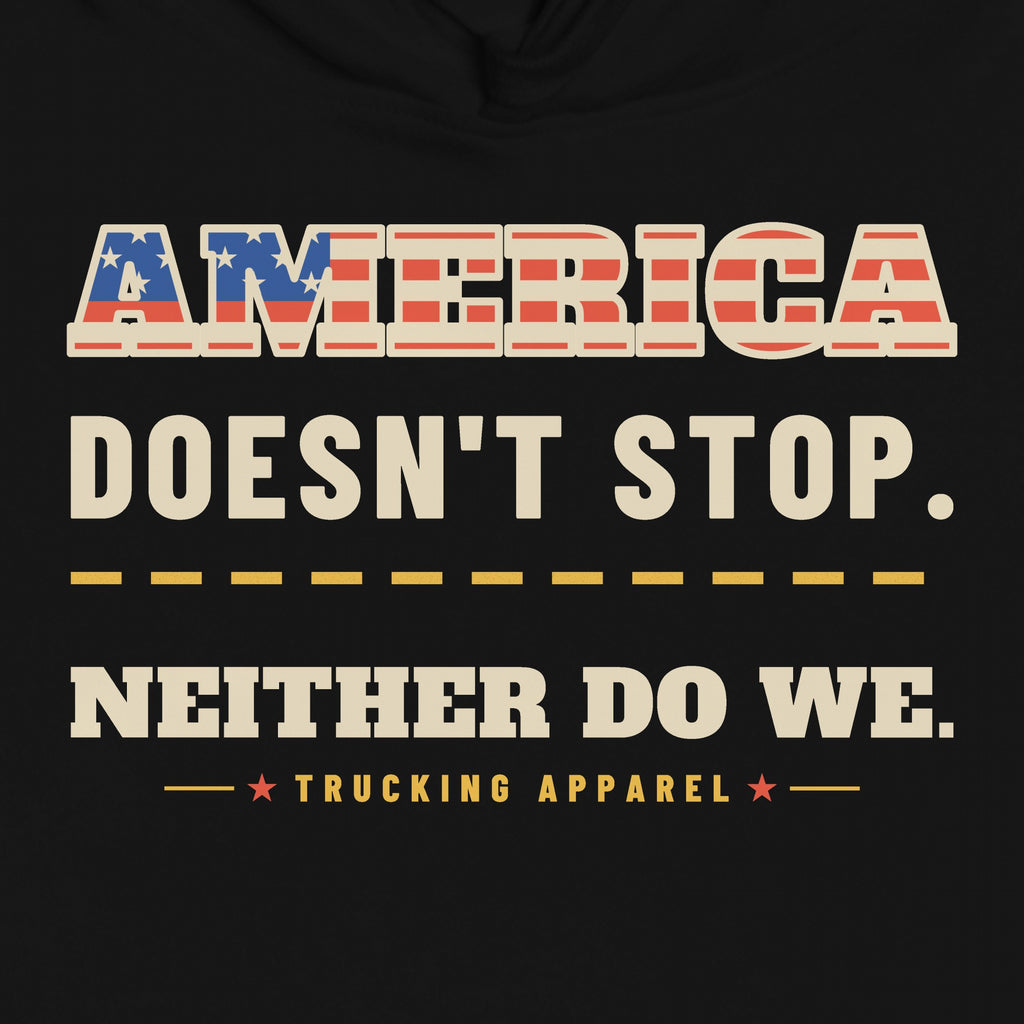 America Doesn't Stop Hoodie in black, close-up of the AMERICA DOESN'T STOP. NEITHER DO WE. front print with stars-and-stripes lettering.
