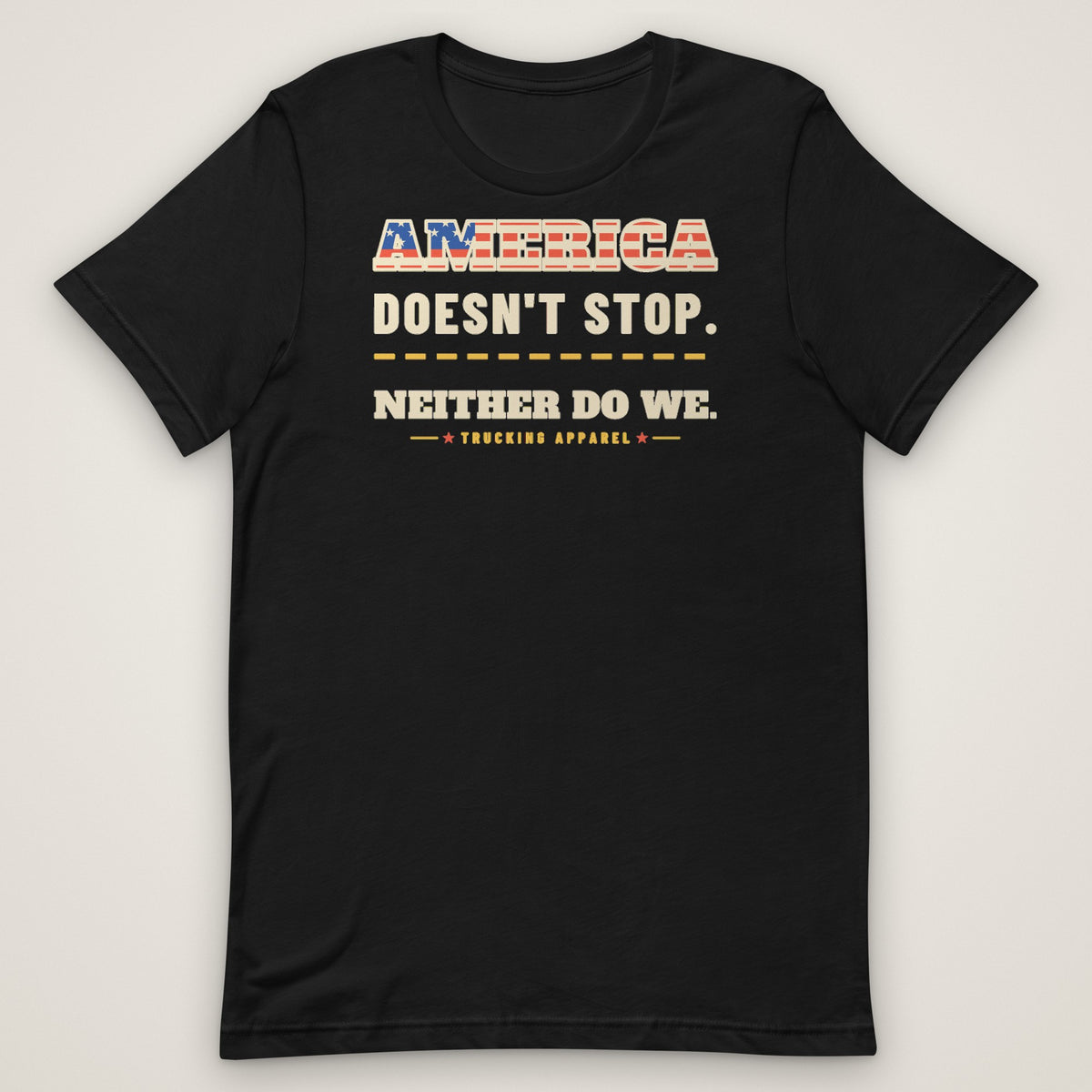America Doesn't Stop Tee in black, front view laid flat showing the AMERICA DOESN'T STOP. NEITHER DO WE. front print with stars-and-stripes lettering.