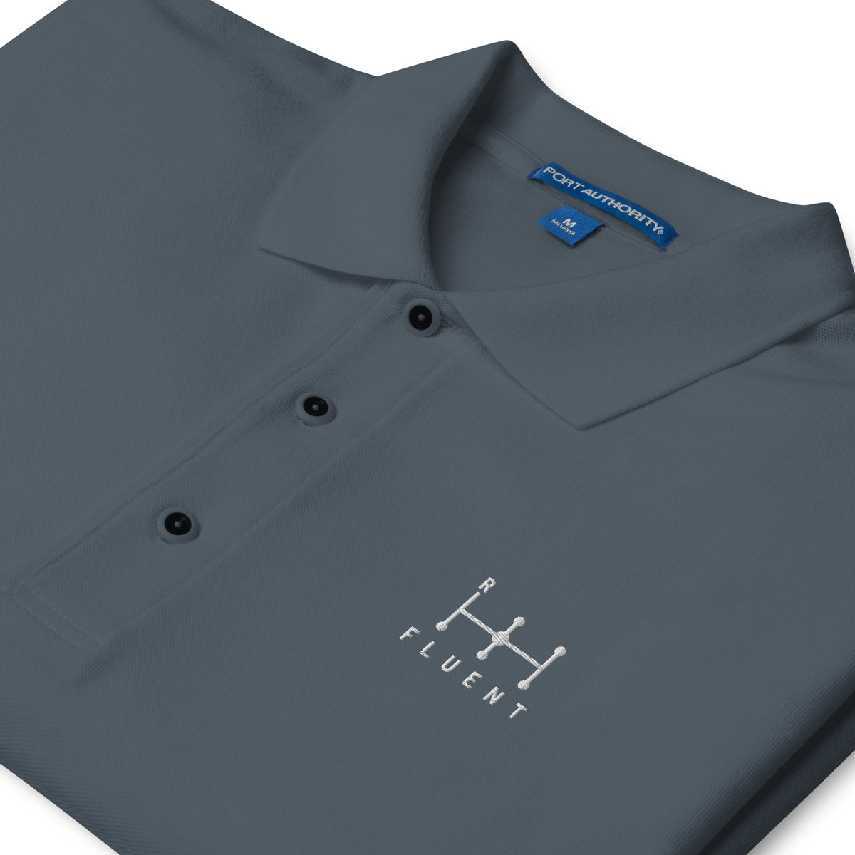Fluent Polo in steel grey, close-up of the embroidery.